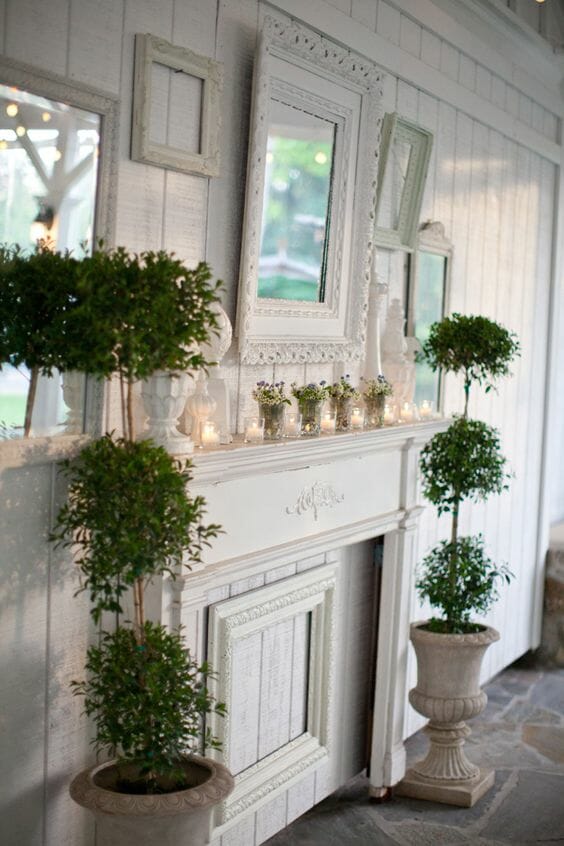 Mantel with frames and flowers