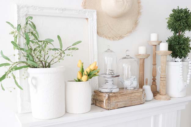 mantel with crocks, candles, hat and books