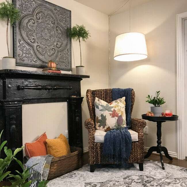 mantel with chair, side table and fall decor