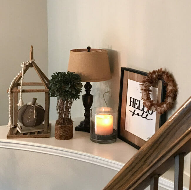 shelf with lamp, topiary, candle and fall decor