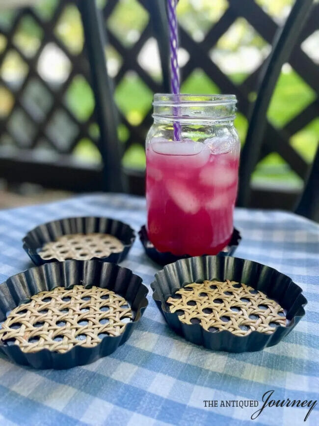 black and rattan mini tart coasters with raspberry drink