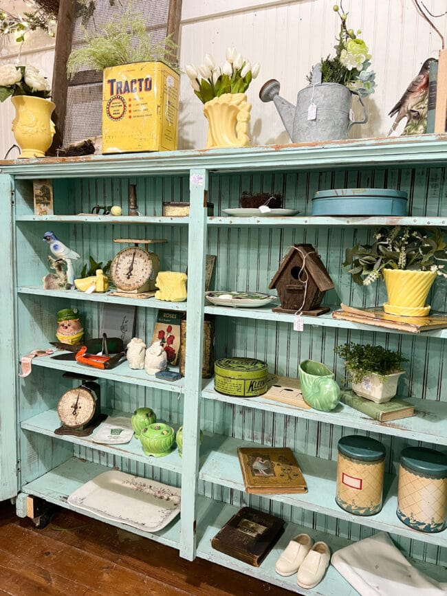 Aqua shelves with vintage pots, and scales 
