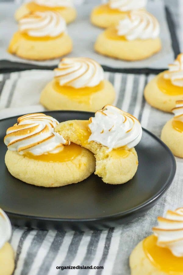 lemon meringue cookies on a black plate