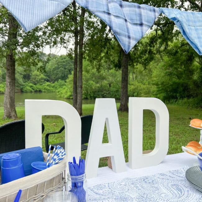 Large DAD letters on a table at the lake