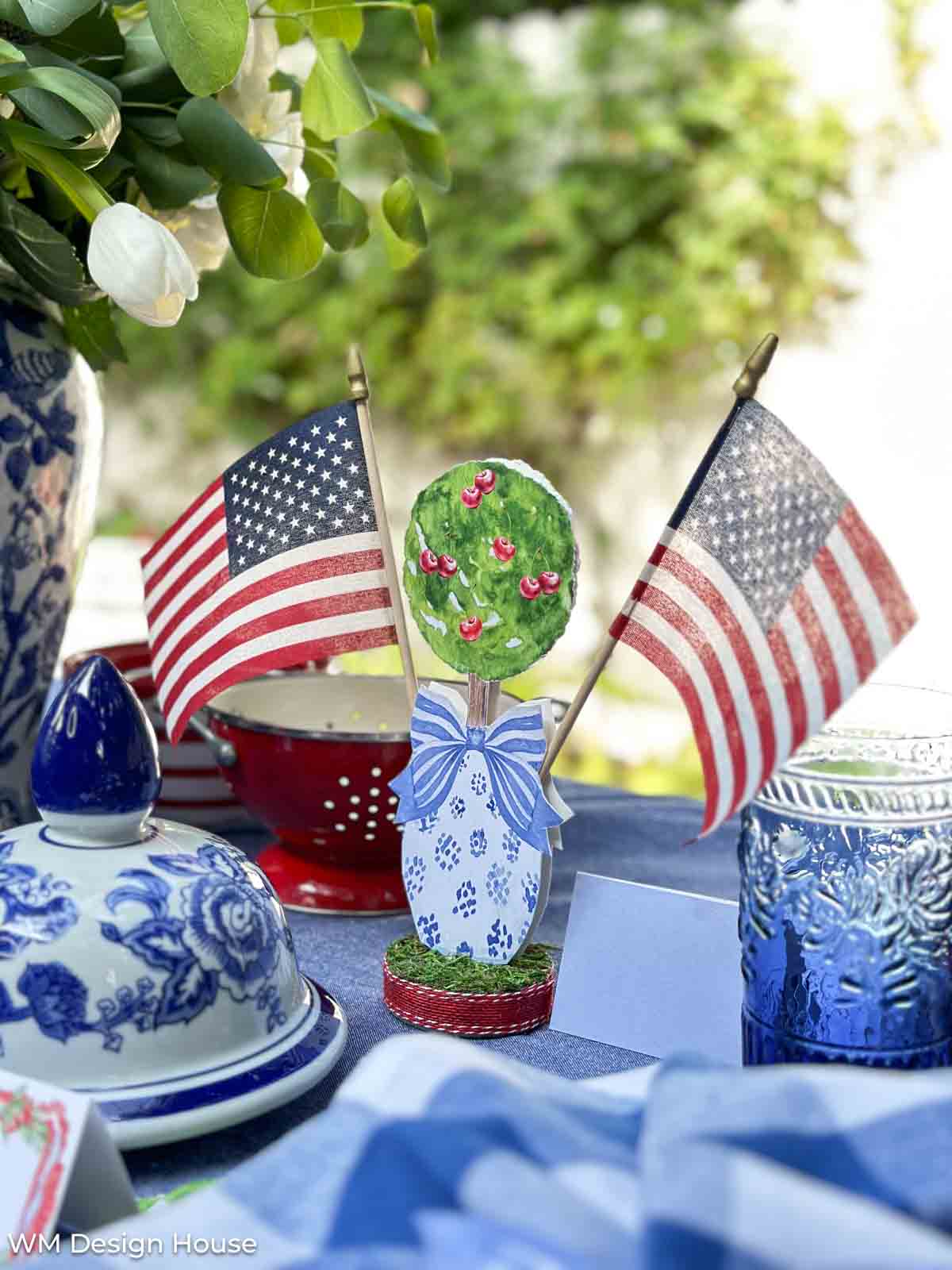 patriotic table setting with blue and white dishes and flags