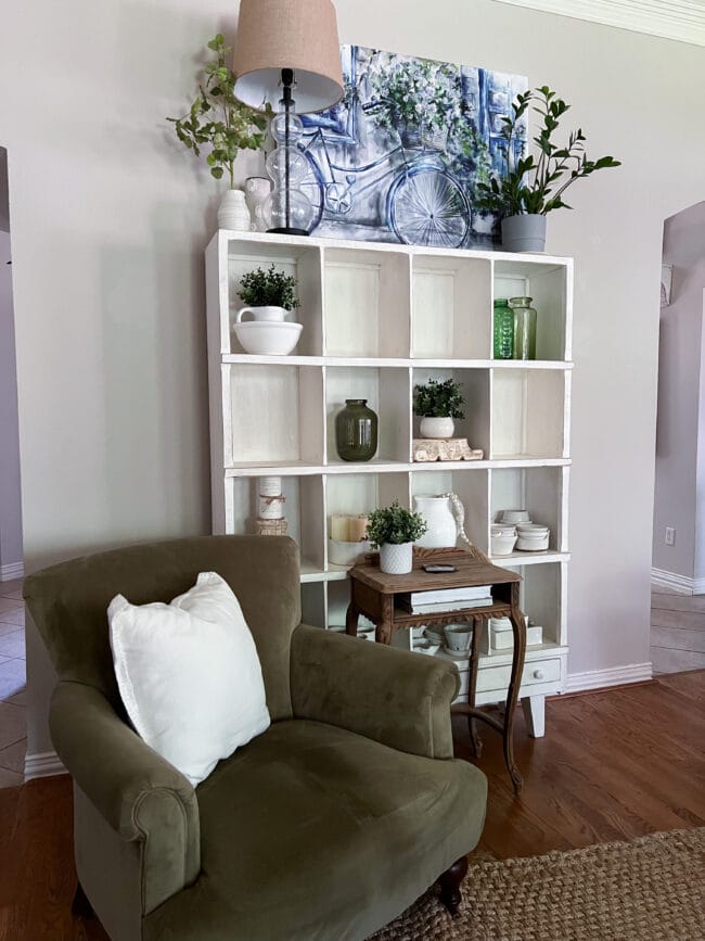 green chair with white cubby shelf