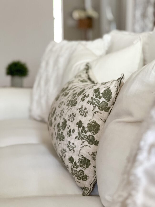 green floral pillow on white sofa