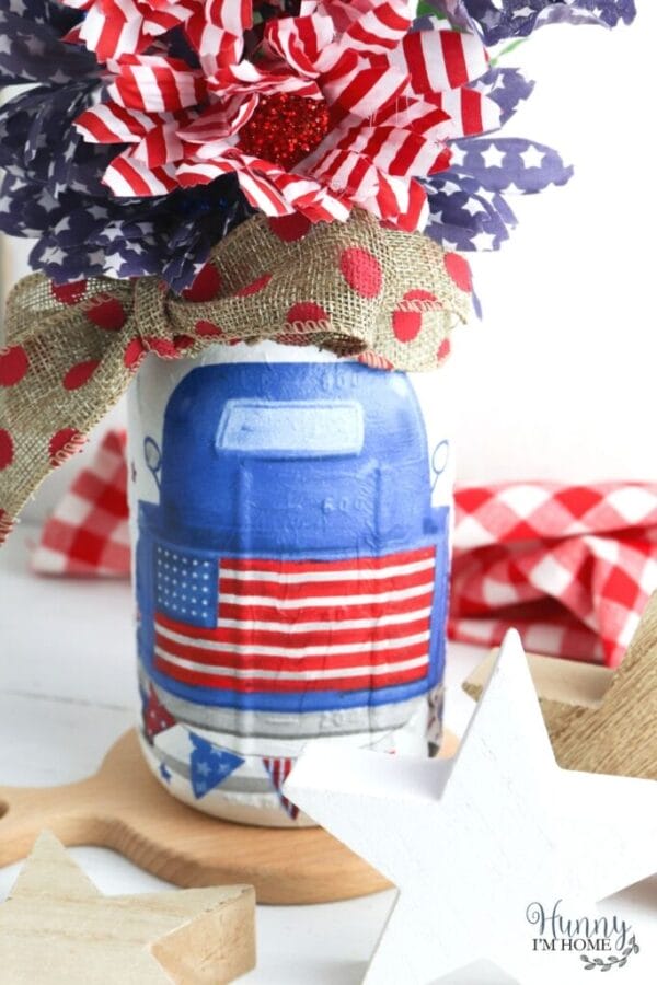 mason jar with blue truck on it and flags inside