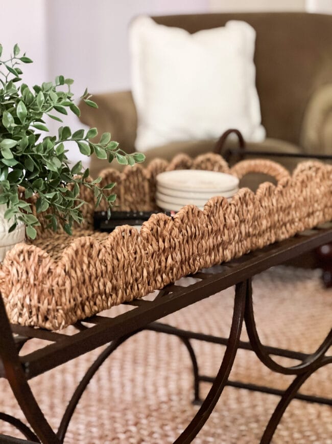 scalloped basket tray on metal bench coffee table with plant