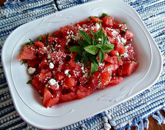 white bowl with cut watermelon and mint