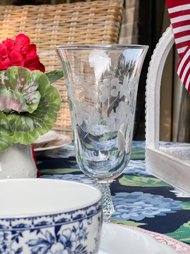 vintage tea glass with red flowers in background