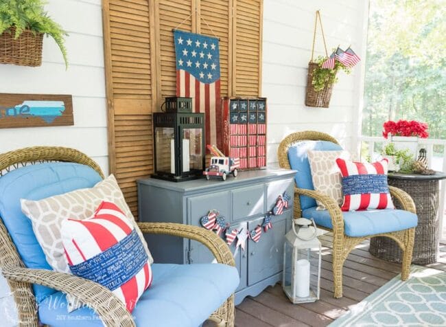 porch decor with blue chest and cushions on the chairs and flag decor