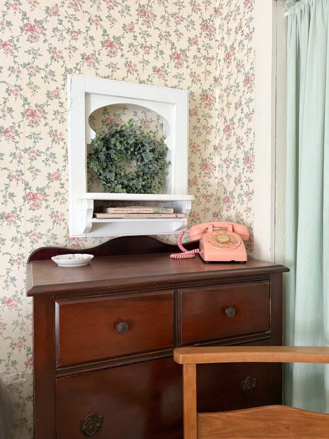 dark chest of drawers with pink phone 