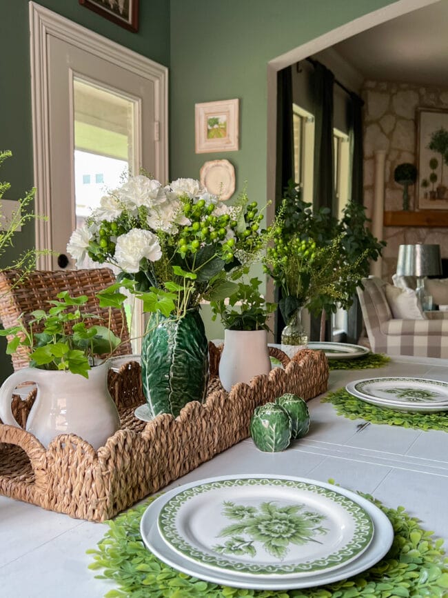 woven basket with cabbage vase with fresh flower and green and white plates