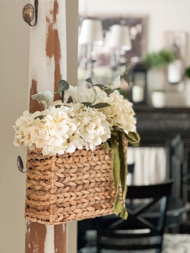 box basket hanging on column with white hydrangeas inside