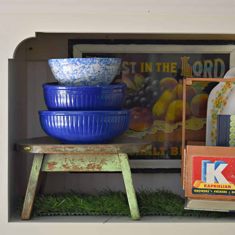 vintage green stool with blue bowls sitting on top