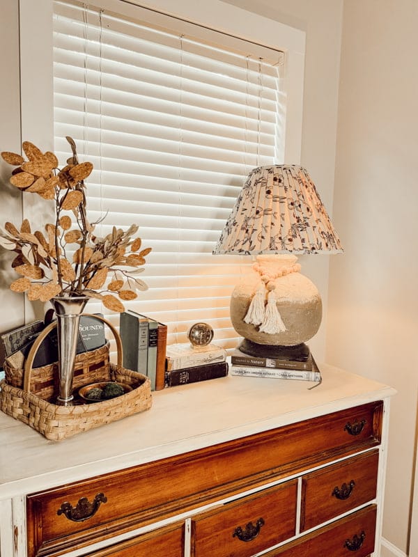 chest with lamp, and basket full of fall decor 