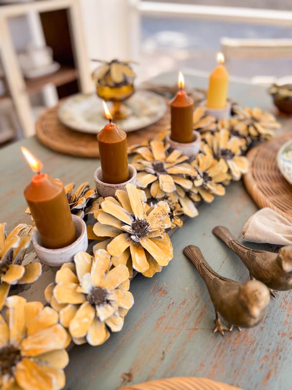 row of handmade sunflowers with candles as a centerpiece