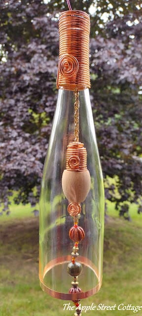 glass bottle made into wind chime with copper wire and wood bead