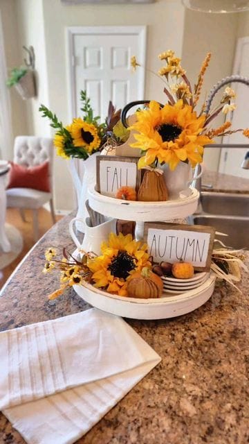 white tiered tray with sunflowers, fall signs and pears