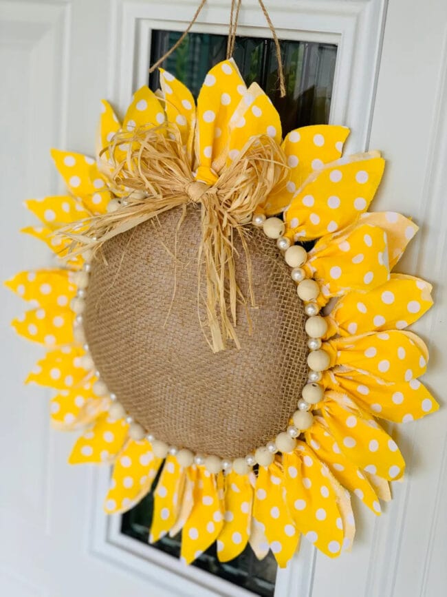 handmade sunflower wreath hanging in door