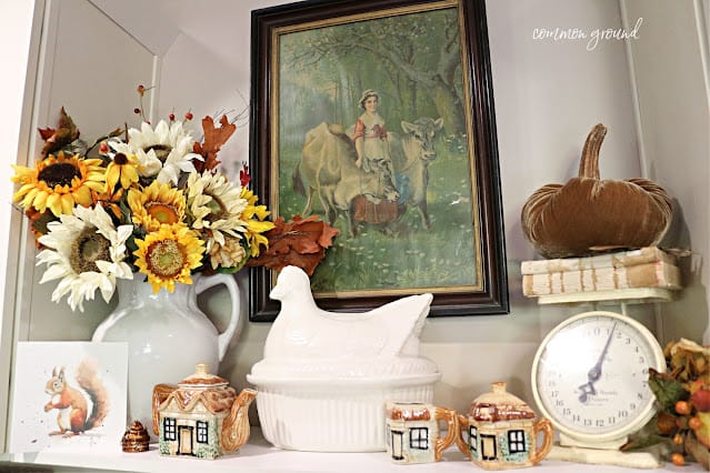 Shelf full of sunflowers, chickens, squirrel print, pumpkin sitting on a scale