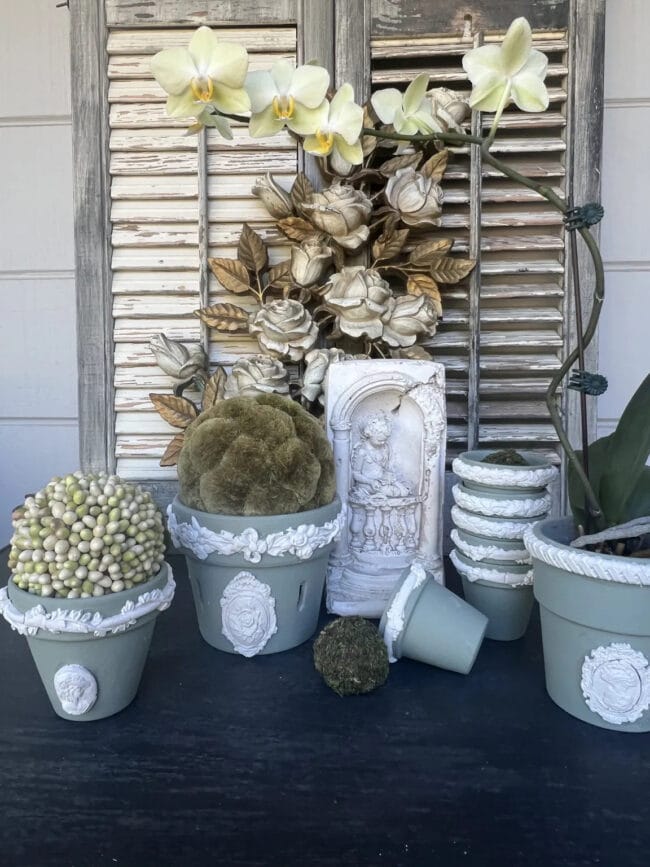 green and white planters with moss balls