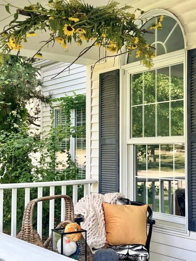 large sun flower and greenery bar hanging on porch