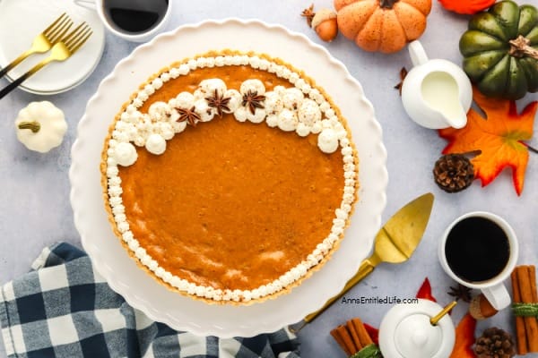 pumpkin pie with fall decor around the plate