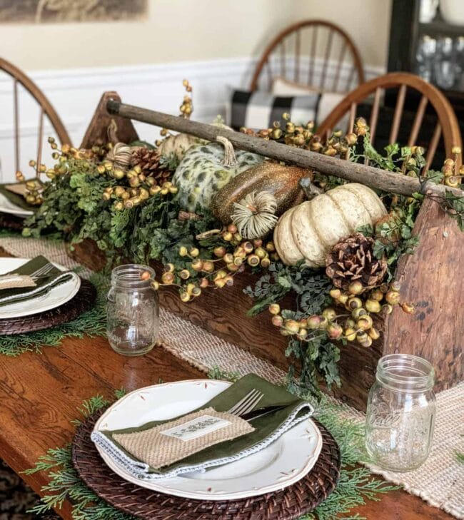 wood toolbox as centerpiece filled with pumpkins, greenery and berries