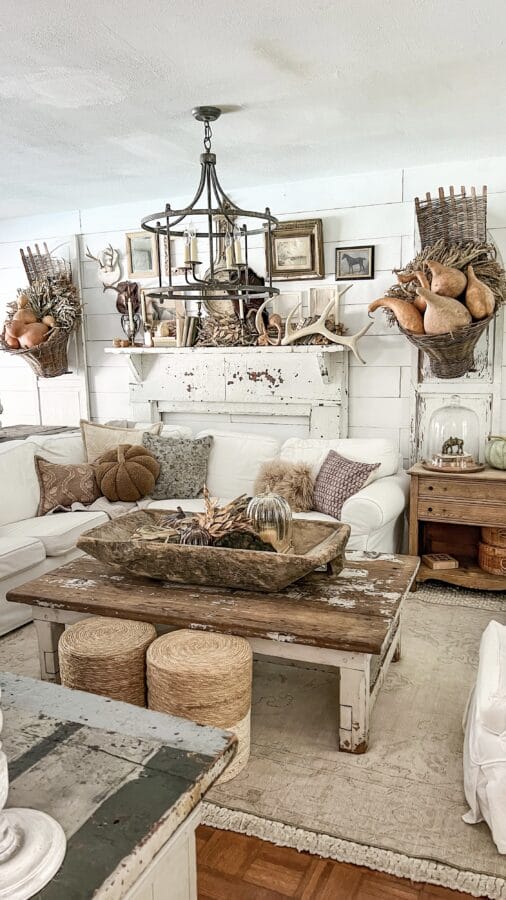 family room with vintage wooden pieces, white furniture and gourds