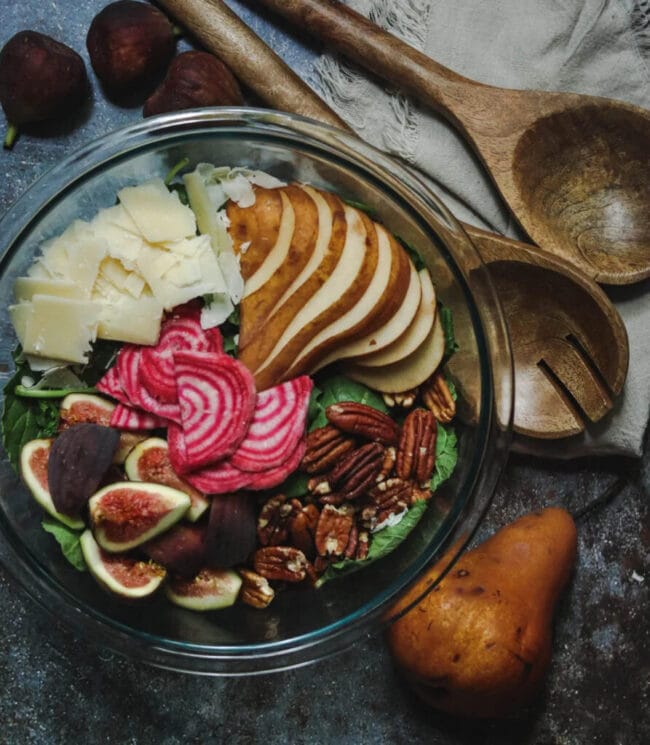 salad with greens, pears, parmesan cheese and figs