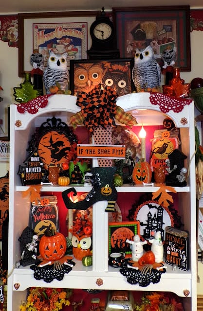 hutch filled with black and orange Halloween decor