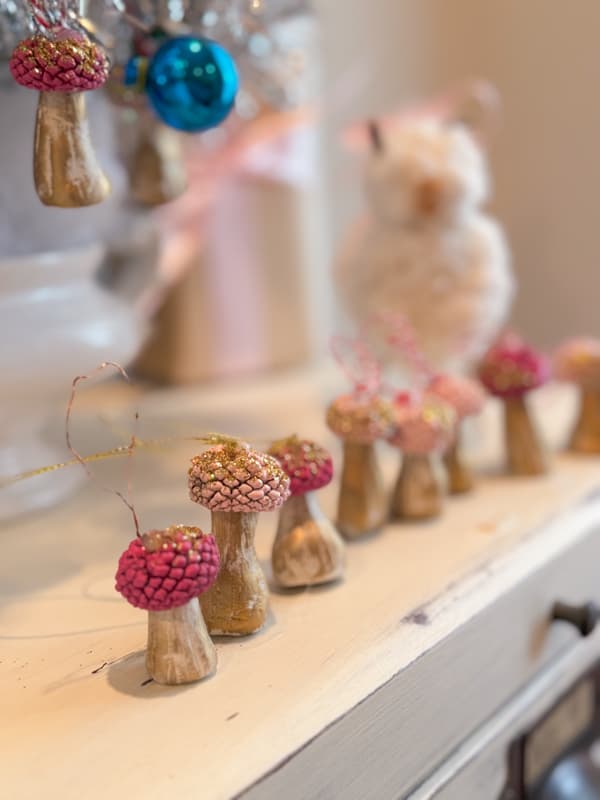 mini mushrooms in gold and pink lined on a dresser