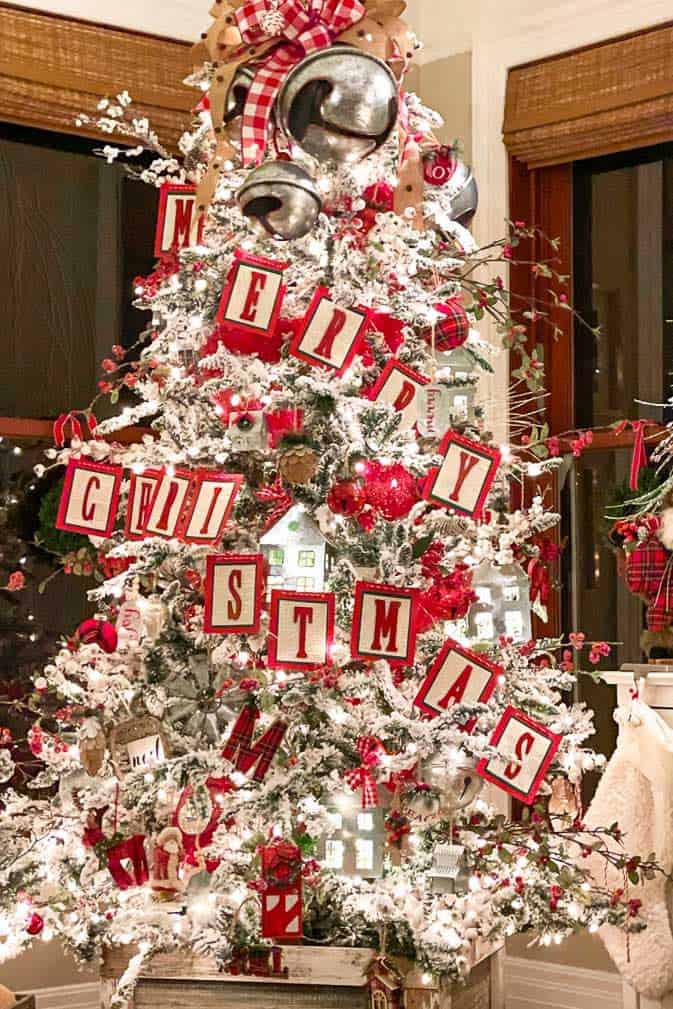 white and red Christmas tree with a Merry Christmas sign on the front