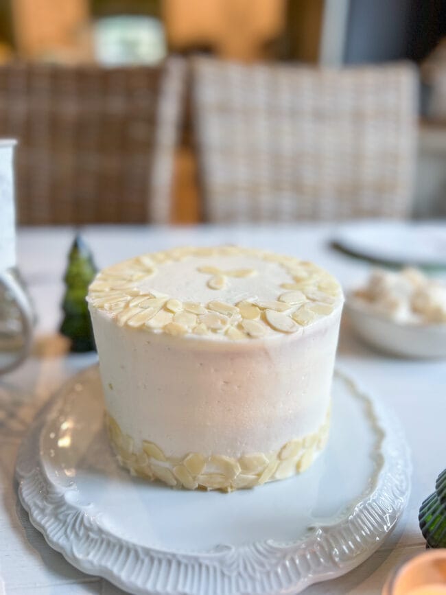 white round cake with blanched almonds on top and sides