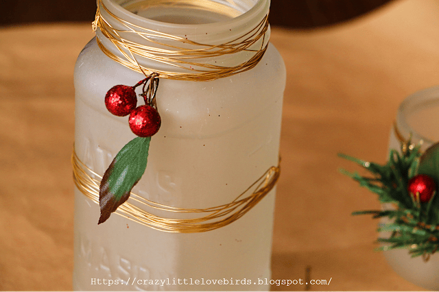 frosted Mason jar with copper wiring and faux berries around top