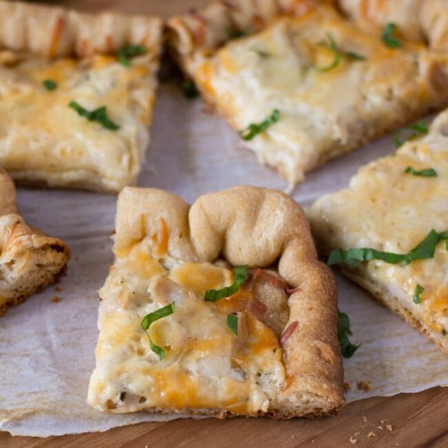 slices of pizza with alfredo sauce and chicken