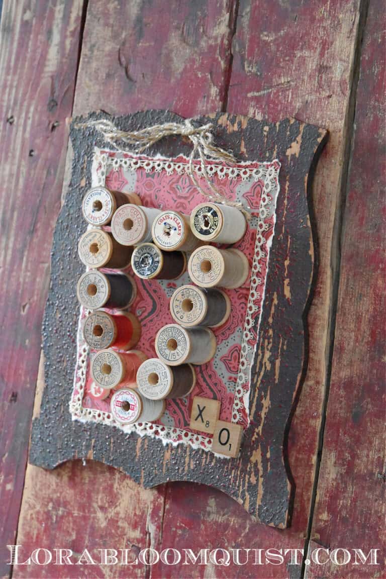 vintage spools in the shape of a heart with a black frame. 