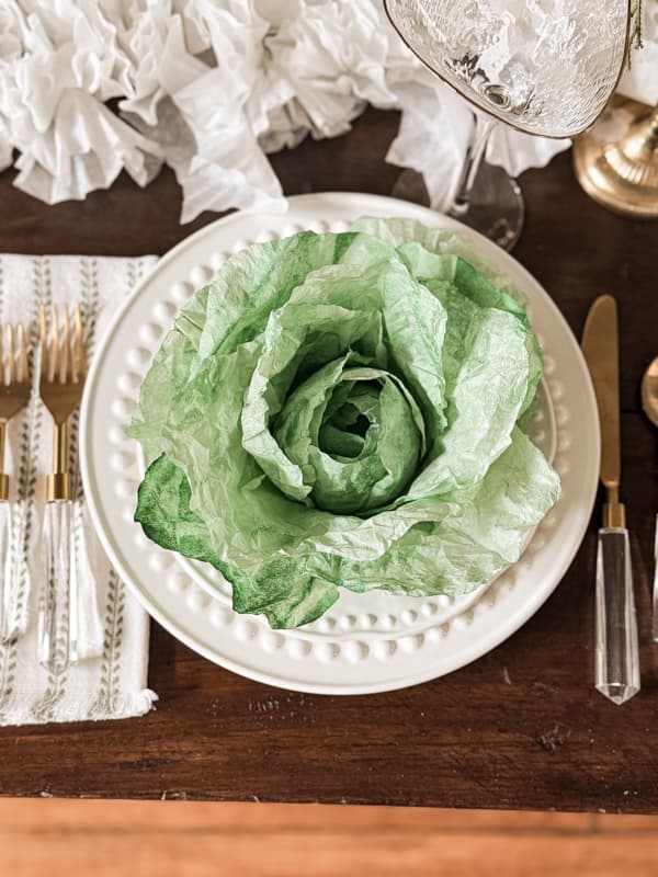 paper cabbage made with coffee filters sitting on a white place for a place setting