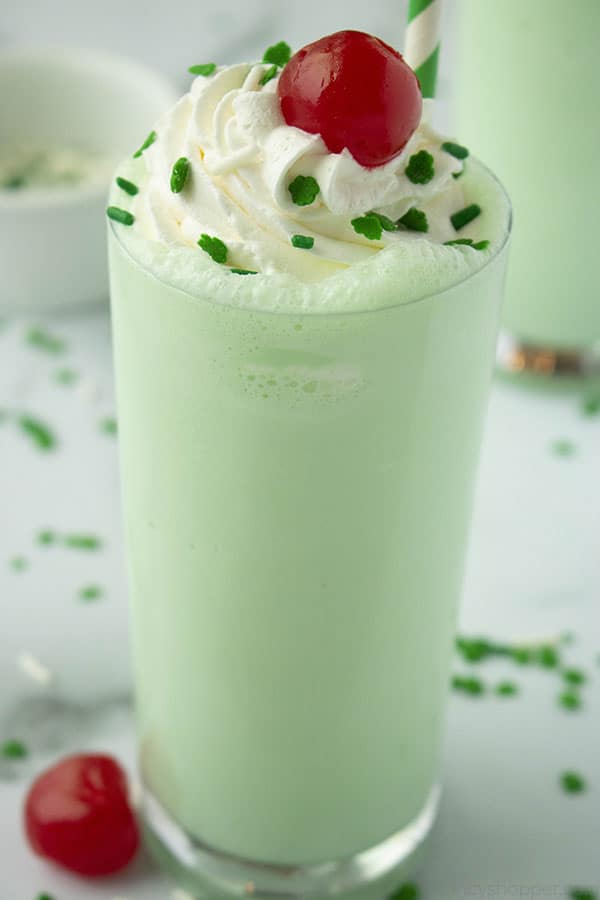 green shake with green sprinkles and a cheery on top