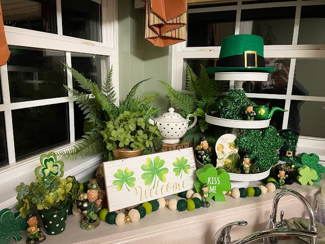 St. Patrick's Day vignette with shamrock hat, plants and a 3 tiered tray