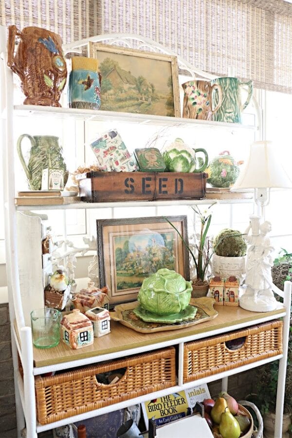 bakers rack with spring decor of little houses, lettuce bowls, seed packets