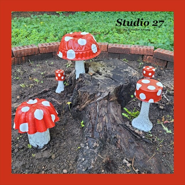 DIY'd red and white polka dotted mushrooms in a mound of dirt