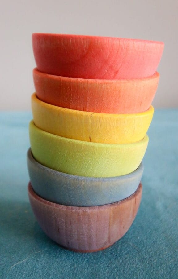 wooden bowls stacked in a rainbow pattern