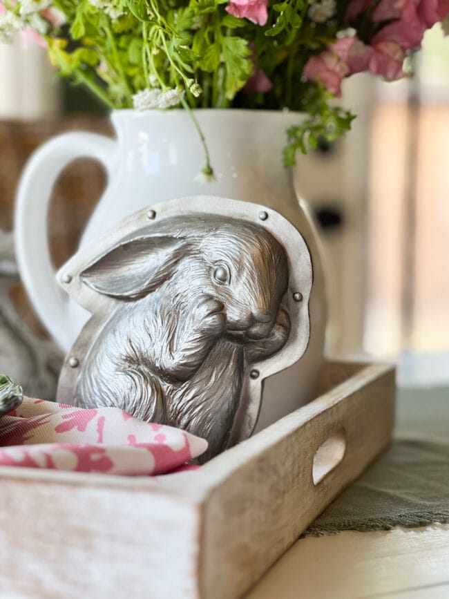 silver bunny mold sitting in a white tray